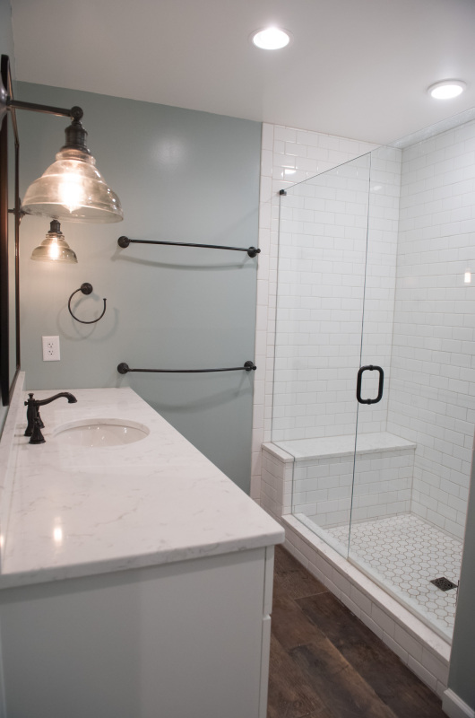 shower with white tile and white vanity